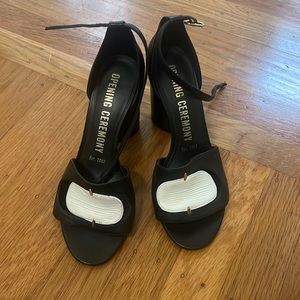 Black block heel with a white design on toe part.